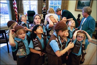 President Bush meets with a Girl Scout Brownies in the Oval Office March 1, 2004. The day after their visit a new program was announced that will soon allow Iraqi children to participate in an Iraqi Boy Scout and Girl Scout program. The history of scouting in Iraq dates back to 1921, but all programs were terminated in the Saddam Hussein era. "The reestablishment of scouting signals a brighter future for Iraq's youth and is another step forward in reconnecting Iraq with the world community," stated the White House in a press release.