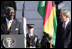 President George W. Bush smiles as President John Agyekum Kufuor of Ghana delivers remarks Monday, Sept. 15, 2008, during the South Lawn Arrival Ceremony for President Kufuor and Mrs. Theresa Kufuor of Ghana on the South Lawn of the White House.