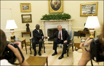 President George W. Bush and President John Agyekum Kufuor of Ghana pause for photos in the Oval Office prior to their meeting Monday, Sept. 15, 2008, at the White House.