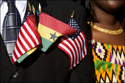 Flags of the United States and Ghana are displayed by a guest attending the South Lawn Arrival Ceremony for President John Agyekum Kufuor of Ghana Monday, Sept. 15, 2008, at the White House.