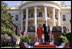 President Bush, President Arroyo, Mrs. Bush and Mr. Arroyo (far left) stand for the playing of the national anthems of the United States and the Philippines at the beginning of the ceremony. White House photo by Eric Draper