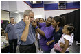 President George W. Bush takes part in a phone call at the Bethany World Prayer Center shelter, Monday, Sept. 5, 2005 in Baton Rouge, Louisiana. The facility is housing hundreds of people displaced by Hurricane Katrina. 