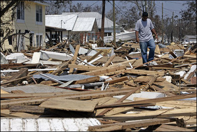 A man walks through the debris amid a neighborhood destroyed by Hurricane Katrina Sept. 2, 2005.