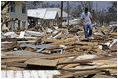 A man walks through the debris amid a neighborhood destroyed by Hurricane Katrina Sept. 2, 2005.