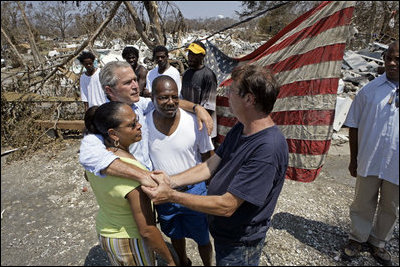President George W. Bush embraces victims of Hurricane Katrina Friday, Sept. 2, 2005, during his tour of the Biloxi, Miss., area. " The President told residents that he had come down to look at the damage first hand and to tell the "good people of this part of the world that the federal government is going to help."