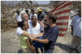 President George W. Bush embraces victims of Hurricane Katrina Friday, Sept. 2, 2005, during his tour of the Biloxi, Miss., area. " The President told residents that he had come down to look at the damage first hand and to tell the "good people of this part of the world that the federal government is going to help."