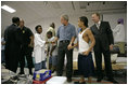 President George W. Bush visits with children inside the Bethany World Prayer Center shelter, Monday, Sept. 5, 2005 in Baton Rouge, Louisiana. The facility is housing hundreds of people displaced by Hurricane Katrina.