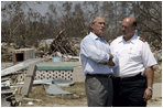 President Bush talks with an official from the Salvation Army during a walking tour of Biloxi, Miss., Sept. 2, 2005. 