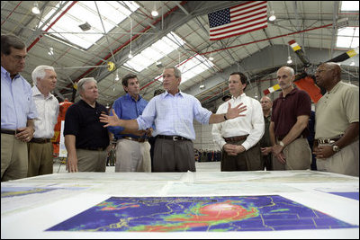 President George W. Bush talks about Hurricane Katrina disaster relief with, from left: Senator Trent Lott, R-Miss.; Senator Thad Cochran, R-Miss.; Mississippi Governor Haley Barbour; Alabama Governor Bob Riley; FEMA Director Mike Brown; Michael Chertoff, Secretary of Homeland Security, and Alphonso Jackson, Secretary of Housing and Urban Development. The President briefed the officials during his tour Friday, Sept. 2, 2005, of the Gulf Coast regions hard hit by the storm. 