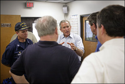 President Bush discusses hurricane damage in the Coast Guard Aviation Training Center at the Mobile Regional Airport Sept. 2, 2005. 