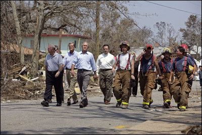 President Bush walks with Biloxi Mayor AJ Holloway, Mississippi Senator Trent Lott and firemen through the neighborhood damaged by Hurricane Katrina in Biloxi, Miss., Sept. 2, 2005. 