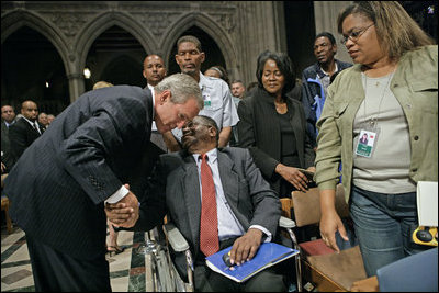 President George W. Bush greets one of the Hurricane Katrina evacuees attending the National Day of Prayer and Remembrance Service at the Washington National Cathedral in Washington, D.C., Friday, Sept. 16, 2005.