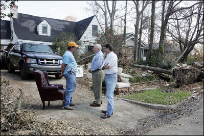 Vice President Dick Cheney and Mayor Greg Warr talk with one resident of a Gulfport, Mississippi neighborhood who's house was damaged recently by Hurricane Katrina Thursday, September 8, 2005.  Vice President and Mrs. Cheney took a walking tour of neighborhood and met with local residents of the area.