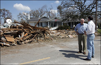 Vice President Dick Cheney talks with Mayor Greg Warr as they take a walking tour of a Gulfport, Mississippi neighborhood which was damaged recently by Hurricane Katrina Thursday, September 8, 2005.