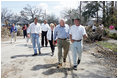 Vice President Dick Cheney walks with a resident of a Gulfport, Mississippi neighborhood Thursday, September 8, 2005. The area was damaged by Hurricane Katrina, which hit both Louisiana and Mississippi on August 29th. Mrs. Cheney and Mayor Greg Warr are also shown walking.