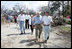 Vice President Dick Cheney walks with a resident of a Gulfport, Mississippi neighborhood Thursday, September 8, 2005. The area was damaged by Hurricane Katrina, which hit both Louisiana and Mississippi on August 29th. Mrs. Cheney and Mayor Greg Warr are also shown walking.