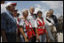 President George W. Bush stands with a group of Red Cross volunteers as he talks with reporters Monday, Sept. 1, 2008 at the Alamo Regional Command Reception Center at Lackland Air Force Base in San Antonio, Texas, where the President participated in a briefing on the response preparation for Hurricane Gustav. Texas Senator Kay Bailey Hutchison and FEMA Administrator David Paulison are seen at right.