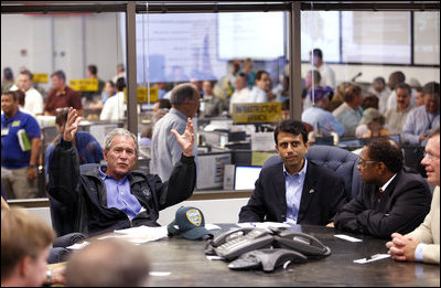 President George W. Bush speaks with federal, state and local officials at the Louisiana Emergency Operations Center in Baton Rouge, Wednesday, Sept. 3, 2008, where he was briefed in the aftermath of Hurricane Gustav. Gustav was a Category 2 storm when it made landfall Monday, in Cocodrie, La. At the request of Gov. Bobby Jindal, center, President Bush Tuesday issued a Major Disaster Declaration for 34 of the state's parishes. Baton Rouge Mayor Kip Holden listens at right.