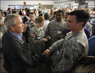 President George W. Bush greets military personnel who assisted with Hurricane Gustav emergency response during his briefing Wednesday, Sept. 3, 2008, at the Louisiana State Emergency Operations Center in Baton Rouge. Acknowledging the response and coordination efforts, the President said, "State government, the local government and the federal government were able to work effectively together."