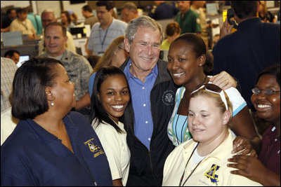 President George W. Bush stands with workers inside the Louisiana State Emergency Operations Center Wednesday, Sept. 3, 2008, in Baton Rouge. Speaking to all those who came to the aide in the wake of Hurricane Gustav, the President said, "I want to thank all the volunteers and the faith-based community that always rises up in a challenge like this. They listen to that universal call to love a neighbor... And that's happening here in Louisiana again."