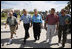 President George W. Bush walks hand-in-hand with Galveston Mayor Lyda Ann Thomas Tuesday, Sept. 16, 2008, during a visit to the Texas area hard hit by last weekend's Hurricane Ike. Walking with them from left are: Charlie Kelly, Emergency Manager Coordinator for the City of Galveston; President Bush, Mayor Thomas, Steve LeBlanc, Galveston City Manager and Texas Congressman Nick Lampson.