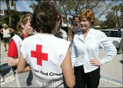 Laura Bush speaks with American Red Cross Disaster Relief workers at the Vero Beach Community Center where disaster relief is offered to local residents Oct. 1, 2004. Vero Beach, Fla., was one of the areas hardest hit by Hurricanes Jeanne and Frances. "See, these volunteers show the true heart of America, because we're a compassionate people, we care when a neighbor hurts, we long to help somebody when help is needed," said President Bush during a visit with volunteers in Stuart, Fla., Sept. 30. "They have the gratitude of all they've served, and they have the admiration for our whole country."