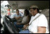 Helping pass out water, President Bush visits with residents affected by Hurricane Frances at an emergency relief center in Ft. Pierce, Fla., Sept. 8, 2004.