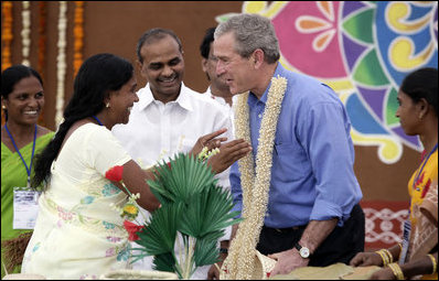 President George W. Bush is presented with a flowered neck garland upon his arrival Friday, March 3, 2006, to Acharya N.G. Ranga Agriculture University in Hyderabad, India.