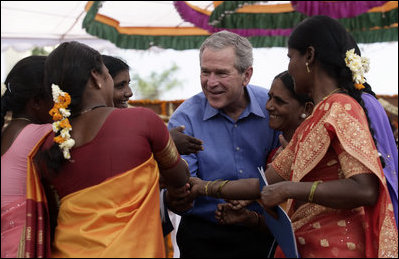 President George W. Bush is surrounded by fans as they pose for photos Friday, March 3, 2006, at the Acharya N.G. Ranga Agriculture University in Hyderabad, India.