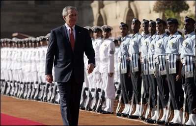 President George W. Bush reviews troops Thursday, March 2, 2006, during the arrival ceremony at Rashtrapati Bhavan, the presidential residence in New Delhi, welcoming he and Laura Bush to India.