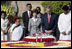 President George W. Bush and Laura Bush are joined by Rajnish Kumar, right, Secretary of the Rajghat Samadhi Committee, and Dr. Nirmila Deshpande, co-Chair of the Rajghat Gandhi Samadhi committee, for a moment of silence at the Mahatma Gandhi Memorial in Rajghat, India.