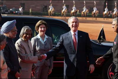 President George W. Bush shakes the hand of India's President A.P.J. Abdul Kalam as he and Mrs. Laura Bush are greeted upon their arrival at Rashtrapati Bhavan, the President's official residence in New Delhi Thursday, March 2, 2006. Also present are Prime Minister Manmohan Singh and his wife, Gusharan Kaur.