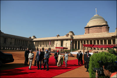 President George W. Bush and Laura Bush arrive at Rashtrapati Bhavan in New Delhi Thursday, March 2, 2006, and are escorted to welcome ceremonies by India's President A.P.J. Abdul Kalam and Prime Minister Manmohan Singh and his wife, Gusharan Kaur.