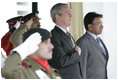 President George W. Bush and Pakistan President Pervez Musharraf stand together during President Bush's official welcome to Aiwan-e-Sadr in Islamabad, Pakistan, Saturday, March 4, 2006.