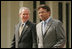 President George W. Bush and Pakistan President Pervez Musharraf walk together to their joint news conference at Aiwan-e-Sadr in Islamabad, Pakistan, Saturday, March 4, 2006.