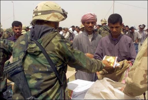 Marines from TF Tarawa hand out needed food and supplies to Iraqi citizens near An Nasariyah, Iraq, while in support of Operation Iraqi Freedom, March 31, 2003. (U.S. Marine Corps Photo by Lance Cpl. Nealy)
