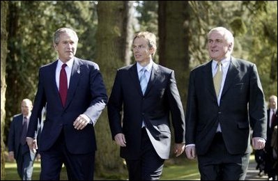 President George W. Bush walks with British Prime Minister Tony Blair, center, and Irish Prime Minister Bertie Ahern at Hillsborough Castle as he prepares to depart Northern Ireland Tuesday, April 8, 2003. White House photo by Paul Morse