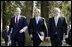 President George W. Bush walks with British Prime Minister Tony Blair, center, and Irish Prime Minister Bertie Ahern at Hillsborough Castle as he prepares to depart Northern Ireland Tuesday, April 8, 2003. White House photo by Paul Morse