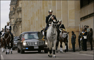 An honor guard escorts a limousine carrying President George W. Bush and Laura Bush Sunday, March 11, 2007, to Casa de Narino, the presidential residence, in Bogota, Colombia. The visit marked the third stop in the couple’s five-country, Latin American visit. White House photo by Paul Morse