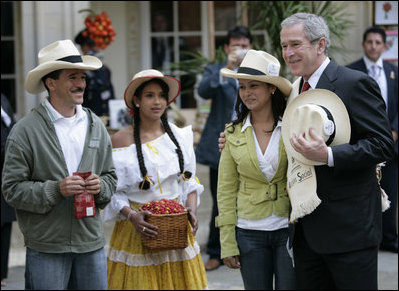 President George W. Bush poses for photos with Colombian coffee growers in the mall of the Presidential Palace in Bogota during his visit Sunday, March 11, 2007. White House photo by Eric Draper