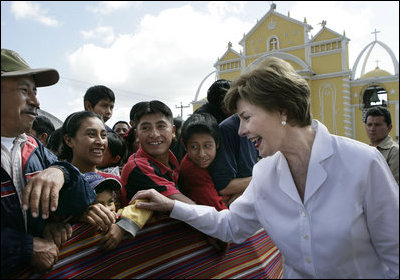 With the Church of the Holy Cross as a backdrop, villagers greet Mrs. Laura Bush Monday, March 12, 2007, as she and President George W. Bush visit Santa Cruz Balanya in the Guatemala countryside. White House photo by Eric Draper