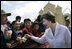 With the Church of the Holy Cross as a backdrop, villagers greet Mrs. Laura Bush Monday, March 12, 2007, as she and President George W. Bush visit Santa Cruz Balanya in the Guatemala countryside. White House photo by Eric Draper