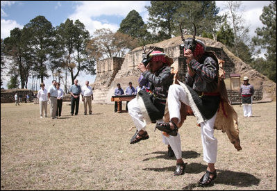 Joined by President Oscar Berger and his wife, Wendy Widmann de Berger, President George W. Bush and Mrs. Laura Bush enjoy a cultural dance Monday, March 12, 2007, during a visit to Iximche, Guatemala. White House photo by Paul Morse