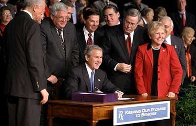 President George W. Bush signs H. R. 1, the Medicare Prescription Drug, Improvement and Modernization Act of 2003, at Constitution Hall in Washington, D.C., Dec. 8, 2003. 