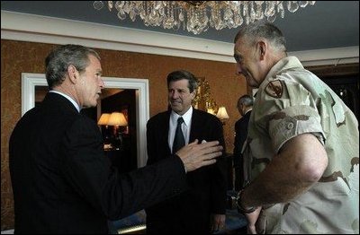President George W. Bush discusses Iraqi reconstruction with Ambassador Paul Bremer, center, and General Tommy Franks in Doha, Qatar, Thursday, June 5, 2003. White House photo by Eric Draper