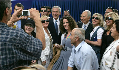 President George W. Bush and President Shimon Peres of Israel are surrounded by members of the media as they pose for photographs during their meeting Wednesday, May 14, 2008, at President Peres' Jerusalem residence.
