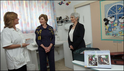 Mrs. Laura Bush and Mrs. Aliza Olmert, spouse of Israeli Prime Minister Ehud Olmert, talk with a staff member during a visit Wednesday, May 14, 2008, to the Tipat Chalav-Gonenim Neighborhood Mother and Child Care Center in Jerusalem.