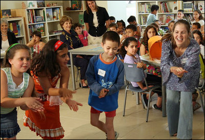 Mrs. Laura Bush looks on as second- and fifth-graders perform a Jewish and Arabic Dance at the Hand in Hand School for Jewish-Arab Education in Jerusalem. Founded in 1997, the Hand in Hand Center runs a network of four bilingual schools in Israel.