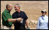 President George W. Bush and Prime Minister Ehud Olmert of Israel, share a moment as they stop during their tour of Masada with Mrs. Laura Bush to learn about the historic fortress's water system.