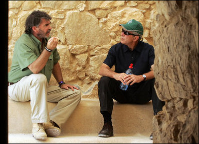 President George W. Bush listens to Eitan Campbell, Director of Masada National Park, as they take a break during their tour Thursday, May 15, 2008, of the historic Israeli fortress located on the eastern fringe of the Judean Desert near the shore of the Dead Sea.